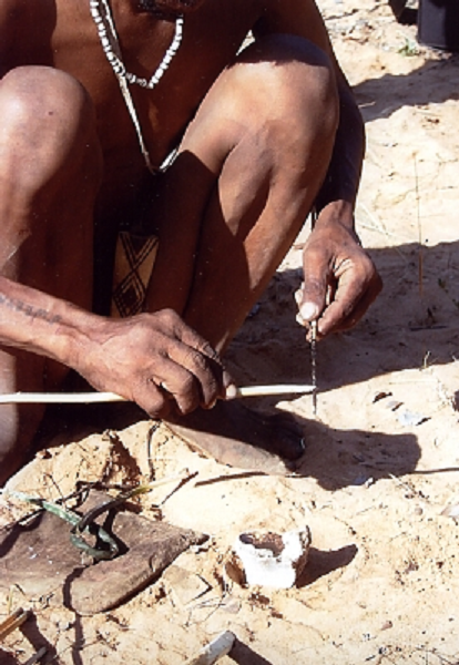 San tribesman crafting arrows