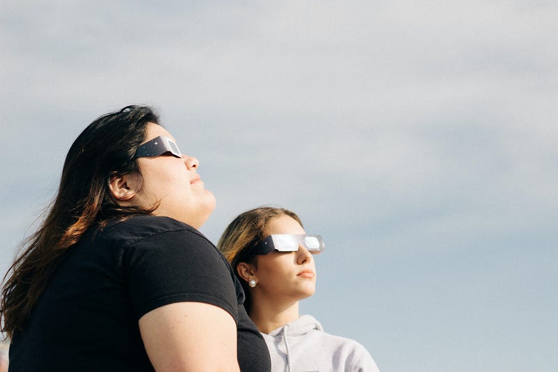 Individuals using solar glasses during an eclipse